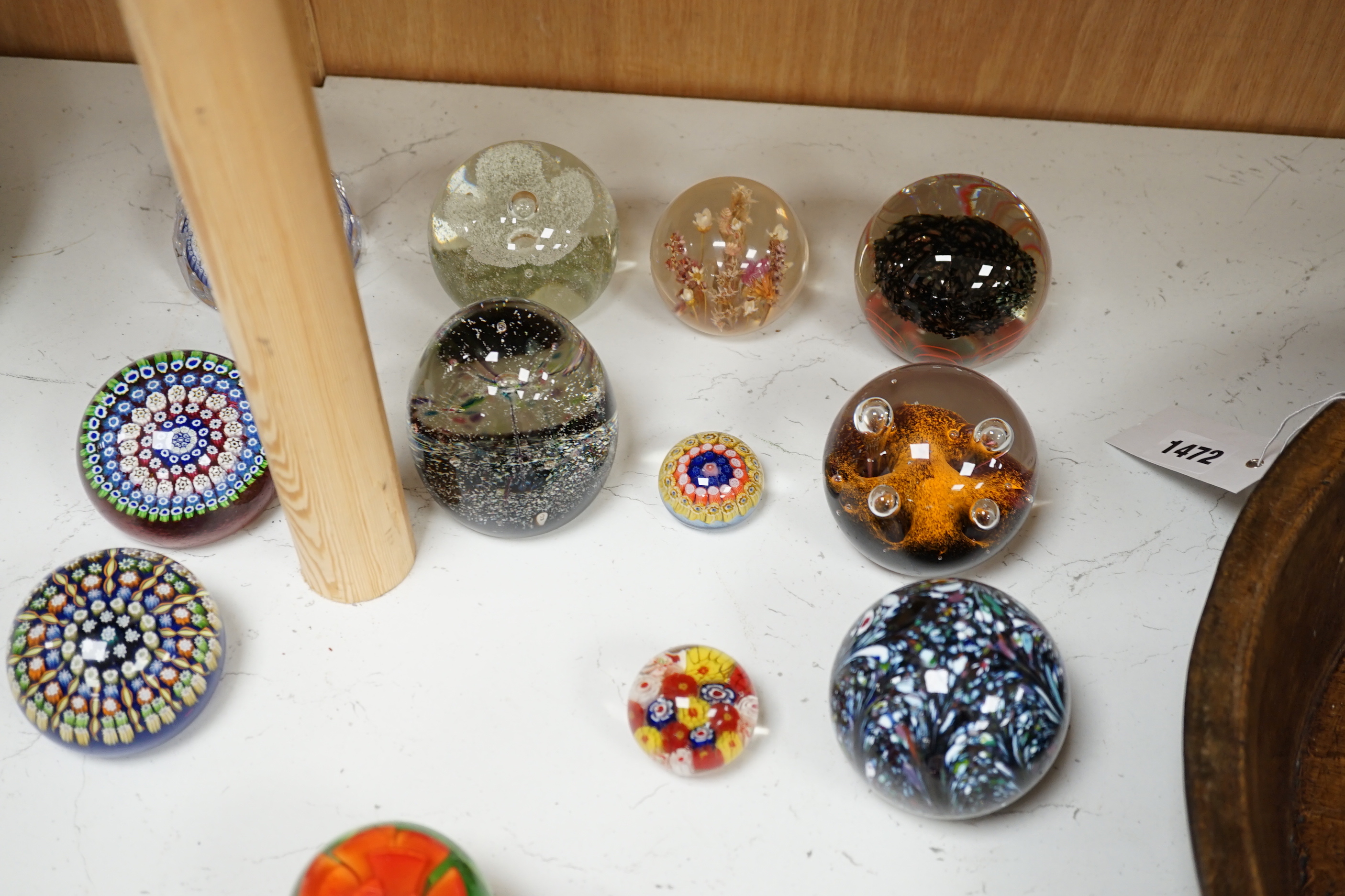 A collection of nineteen glass paperweights; mostly Caithness with two being Whitefriars and another Perthshire